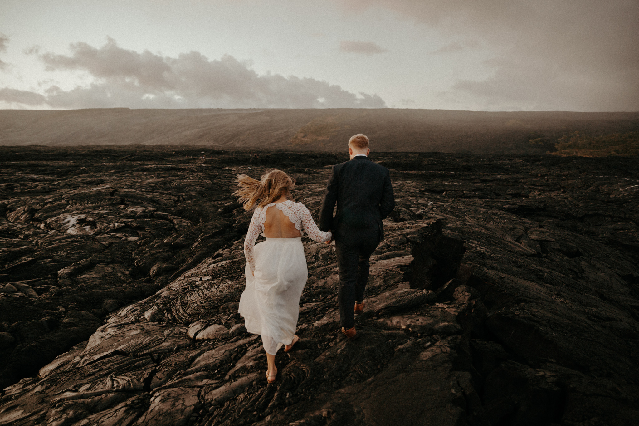 Adventurous elopement on the Big Island of Hawaii with a waterfall, a tropical jungle, and a lava field with molten lava flow. Images by Destination Wedding Photographer Victoria Selman