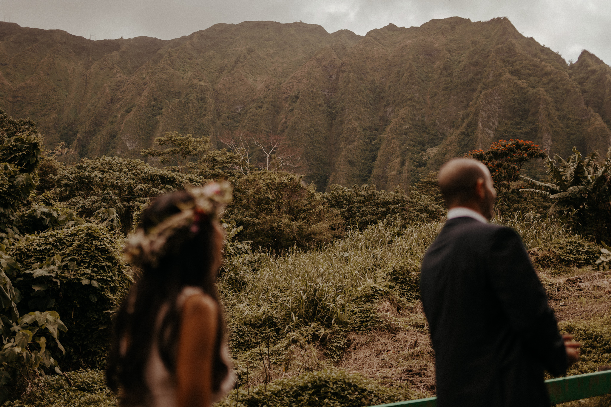 Oahu, Hawaii elopement location with mountains in background and a bridal flower crown called a lei po’o, images by destination wedding photographer Victoria Selman