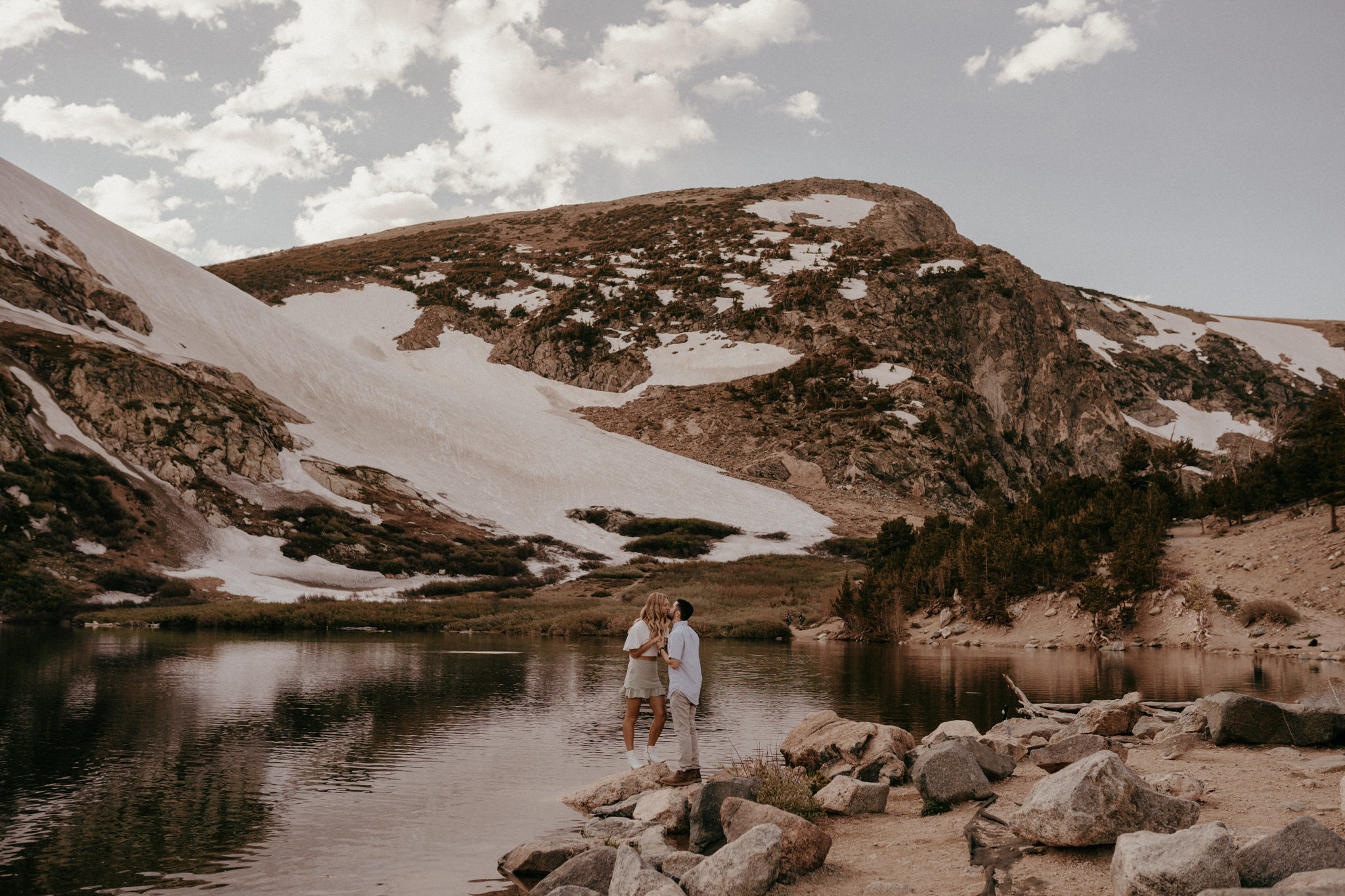 Glacier hike engagement session in the rocky mountains with snow, champagne, and a gorgeous lake view, boulder colorado elopement photographer