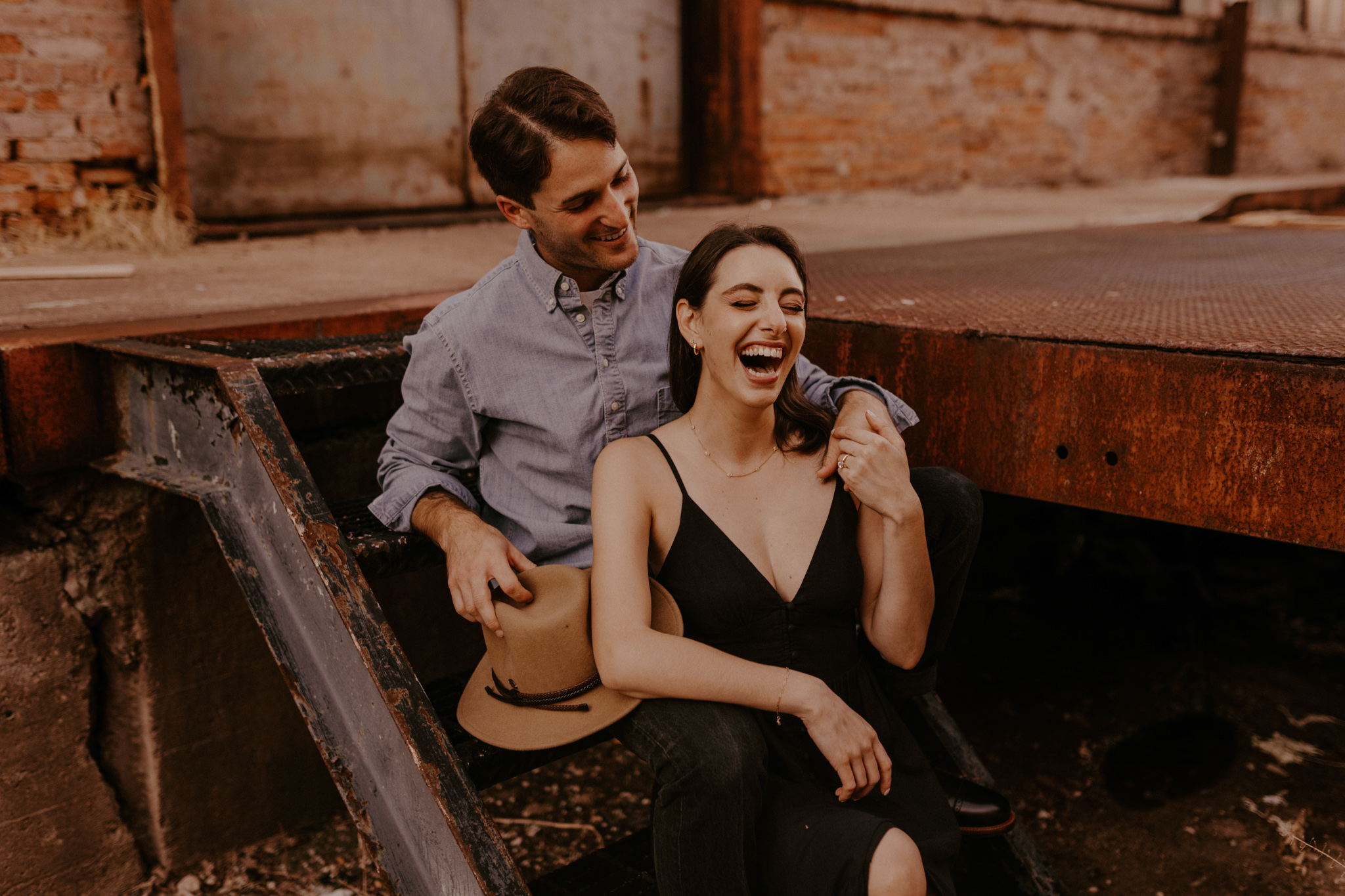 Summer baltimore engagement with their golden retriever dogs, a picnic in a park, and a moody modern industrial location in the city